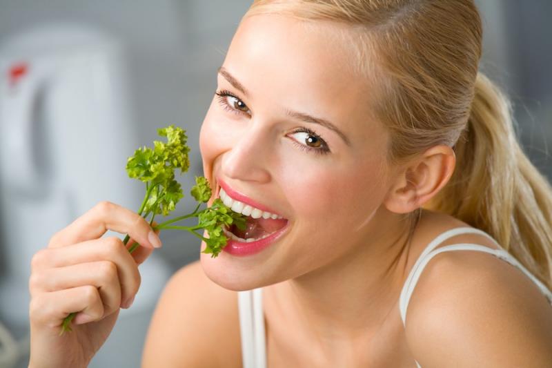 Woman eating parsley